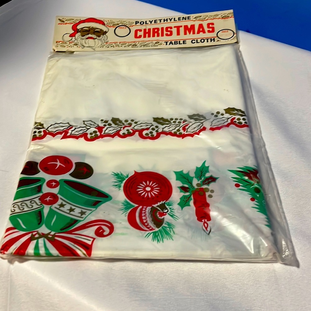 L New in package polyethylene Christmas table cloth 48 x 72” vintage
